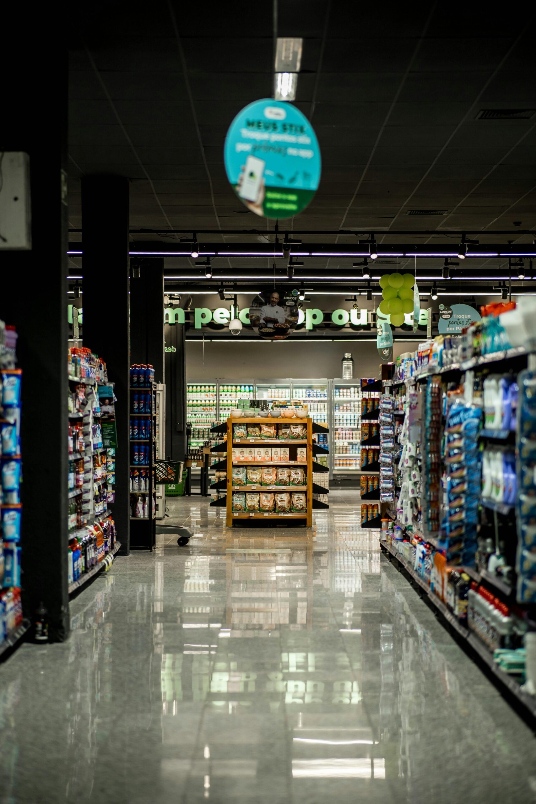 A well-lit grocery store aisle with stocked shelves, reflecting a serene shopping environment.